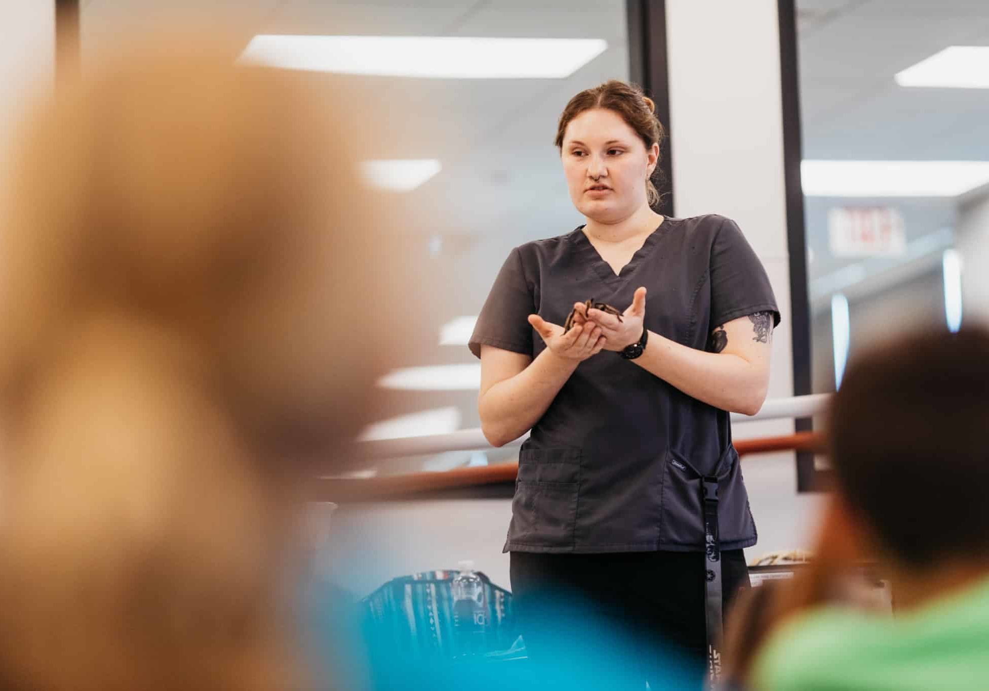 an NHS staff member doing a presentation for Camp Kindness campers